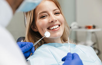 young woman smiling during dental examination