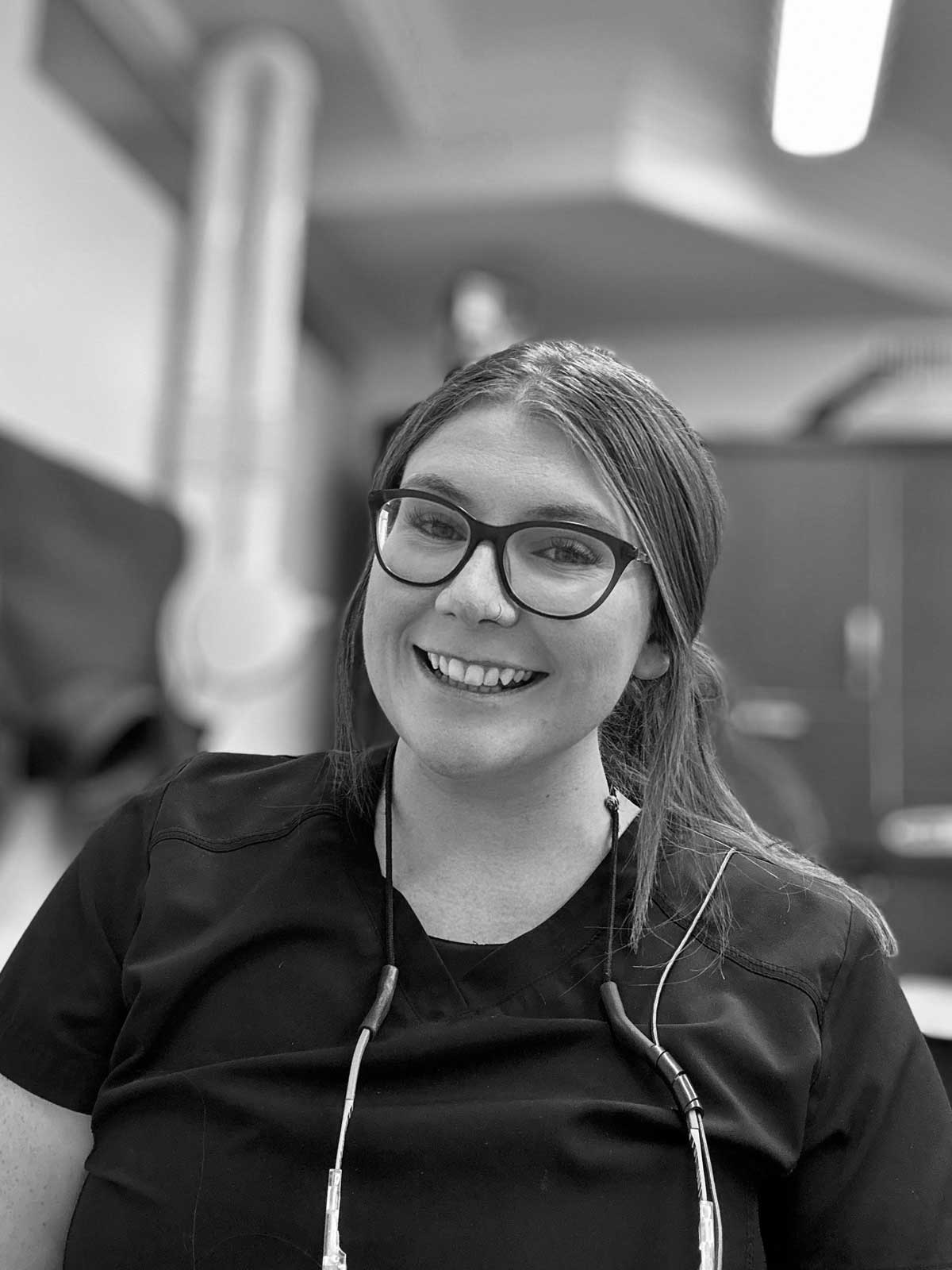 Portrait of Jackie in her scrubs, smiling at camera